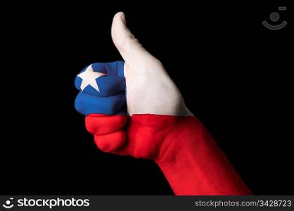 Hand with thumb up gesture in colored chile national flag as symbol of excellence, achievement, good, - for tourism and touristic advertising, positive political, cultural, social management of country