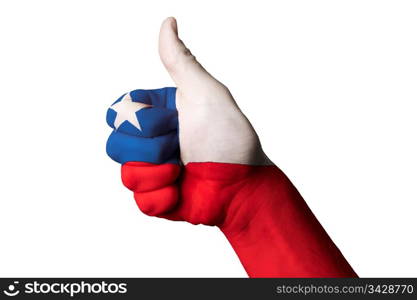 Hand with thumb up gesture in colored chile national flag as symbol of excellence, achievement, good, - for tourism and touristic advertising, positive political, cultural, social management of country