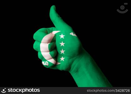 Hand with thumb up gesture in colored comoros national flag as symbol of excellence, achievement, good, - for tourism and touristic advertising, positive political, cultural, social management of country