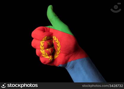 Hand with thumb up gesture in colored eritrea national flag as symbol of excellence, achievement, good, - for tourism and touristic advertising, positive political, cultural, social management of country