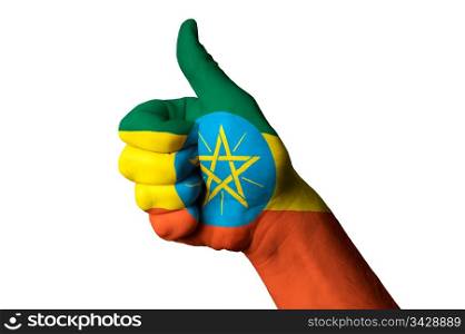 Hand with thumb up gesture in colored ethiopia national flag as symbol of excellence, achievement, good, - for tourism and touristic advertising, positive political, cultural, social management of country
