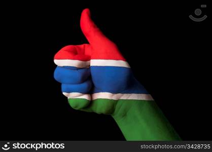 Hand with thumb up gesture in colored gambia national flag as symbol of excellence, achievement, good, - for tourism and touristic advertising, positive political, cultural, social management of country