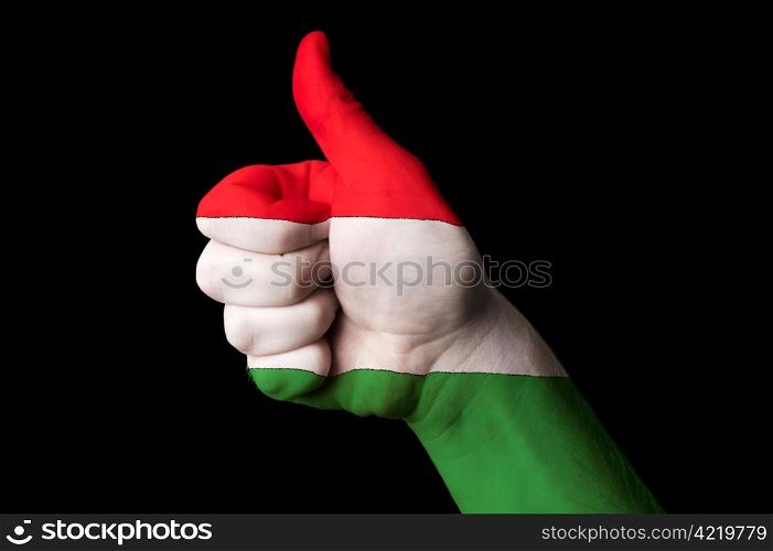 Hand with thumb up gesture in colored hungary national flag as symbol of excellence, achievement, good, - useful for tourism and touristic advertising and also current positive political, cultural, social management of state or country