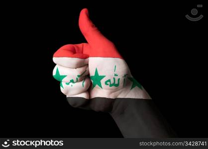 Hand with thumb up gesture in colored iraq national flag as symbol of excellence, achievement, good, - for tourism and touristic advertising, positive political, cultural, social management of country