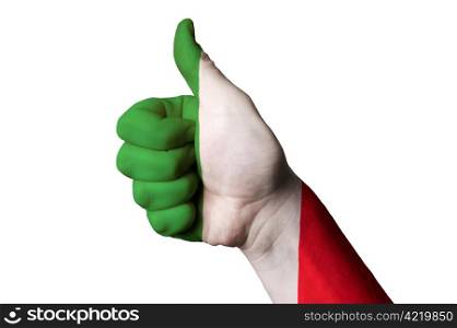 Hand with thumb up gesture in colored italy national flag as symbol of excellence, achievement, good, - useful for tourism and touristic advertising and also current positive political, cultural, social management of state or country