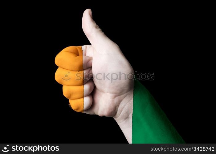 Hand with thumb up gesture in colored ivory coast national flag as symbol of excellence, achievement, good, - for tourism and touristic advertising, positive political, cultural, social management of country