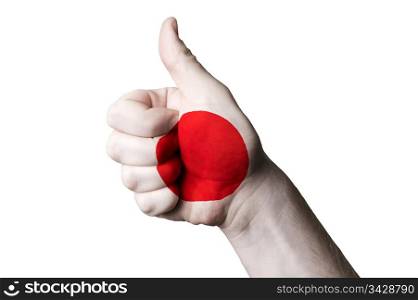 Hand with thumb up gesture in colored japan national flag as symbol of excellence, achievement, good, - for tourism and touristic advertising, positive political, cultural, social management of country