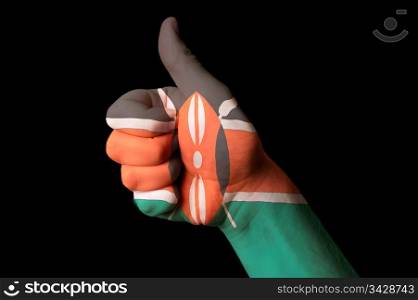 Hand with thumb up gesture in colored kenya national flag as symbol of excellence, achievement, good, - for tourism and touristic advertising, positive political, cultural, social management of country