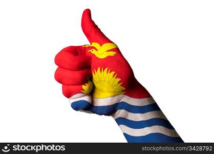 Hand with thumb up gesture in colored kiribati national flag as symbol of excellence, achievement, good, - for tourism and touristic advertising, positive political, cultural, social management of country