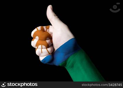 Hand with thumb up gesture in colored lesotho national flag as symbol of excellence, achievement, good, - for tourism and touristic advertising, positive political, cultural, social management of country