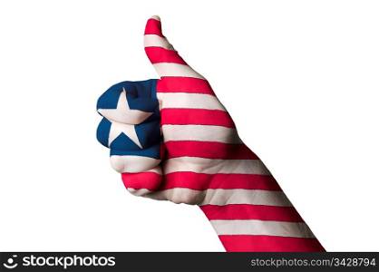 Hand with thumb up gesture in colored liberia national flag as symbol of excellence, achievement, good, - for tourism and touristic advertising, positive political, cultural, social management of country