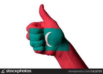 Hand with thumb up gesture in colored maldives national flag as symbol of excellence, achievement, good, - for tourism and touristic advertising, positive political, cultural, social management of country