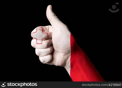 Hand with thumb up gesture in colored malta national flag as symbol of excellence, achievement, good, - useful for tourism and touristic advertising and also current positive political, cultural, social management of state or country