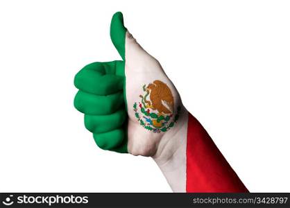 Hand with thumb up gesture in colored mexico national flag as symbol of excellence, achievement, good, - for tourism and touristic advertising, positive political, cultural, social management of country