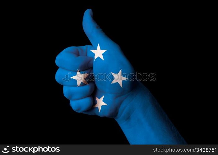 Hand with thumb up gesture in colored micronesia national flag as symbol of excellence, achievement, good, - for tourism and touristic advertising, positive political, cultural, social management of country