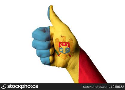 Hand with thumb up gesture in colored moldova national flag as symbol of excellence, achievement, good, - useful for tourism and touristic advertising and also current positive political, cultural, social management of state or country