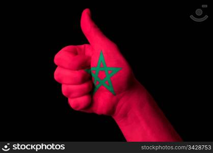 Hand with thumb up gesture in colored morocco national flag as symbol of excellence, achievement, good, - for tourism and touristic advertising, positive political, cultural, social management of country