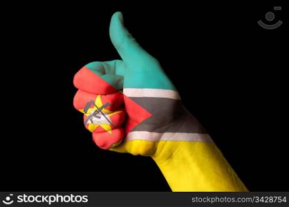 Hand with thumb up gesture in colored mozambique national flag as symbol of excellence, achievement, good, - for tourism and touristic advertising, positive political, cultural, social management of country
