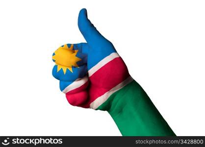 Hand with thumb up gesture in colored namibia national flag as symbol of excellence, achievement, good, - for tourism and touristic advertising, positive political, cultural, social management of country