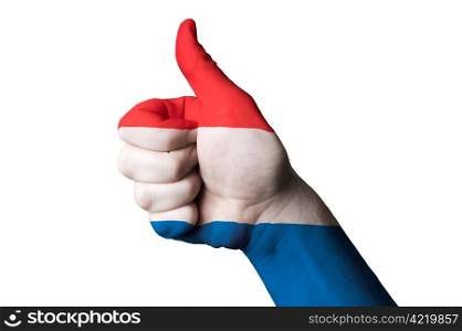 Hand with thumb up gesture in colored netherlands national flag as symbol of excellence, achievement, good, - useful for tourism and touristic advertising and also current positive political, cultural, social management of state or country