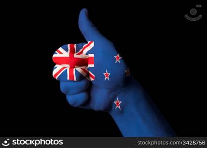 Hand with thumb up gesture in colored new zealand national flag as symbol of excellence, achievement, good, - for tourism and touristic advertising, positive political, cultural, social management of country