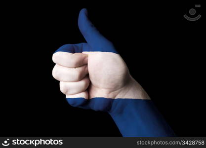 Hand with thumb up gesture in colored nicaragua national flag as symbol of excellence, achievement, good, - for tourism and touristic advertising, positive political, cultural, social management of country