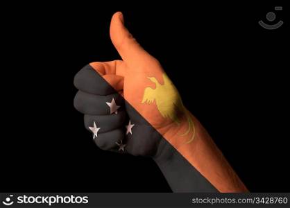Hand with thumb up gesture in colored papua new guinea national flag as symbol of excellence, achievement, good, - for tourism and touristic advertising, positive political, cultural, social management of country