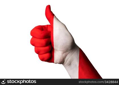 Hand with thumb up gesture in colored peru national flag as symbol of excellence, achievement, good, - for tourism and touristic advertising, positive political, cultural, social management of country
