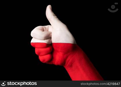 Hand with thumb up gesture in colored poland national flag as symbol of excellence, achievement, good, - useful for tourism and touristic advertising and also current positive political, cultural, social management of state or country