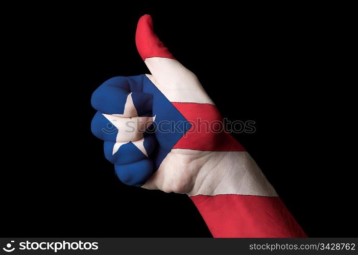 Hand with thumb up gesture in colored puertorico national flag as symbol of excellence, achievement, good, - for tourism and touristic advertising, positive political, cultural, social management of country