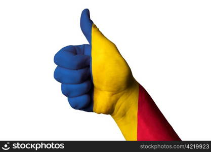 Hand with thumb up gesture in colored romania national flag as symbol of excellence, achievement, good, - useful for tourism and touristic advertising and also current positive political, cultural, social management of state or country