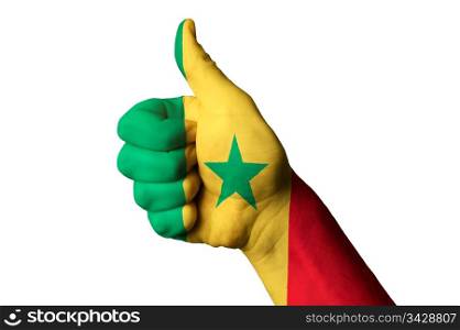 Hand with thumb up gesture in colored senegal national flag as symbol of excellence, achievement, good, - for tourism and touristic advertising, positive political, cultural, social management of country