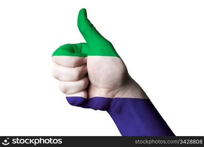 Hand with thumb up gesture in colored sierra leone national flag as symbol of excellence, achievement, good, - for tourism and touristic advertising, positive political, cultural, social management of country