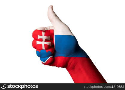 Hand with thumb up gesture in colored slovakia national flag as symbol of excellence, achievement, good, - useful for tourism and touristic advertising and also current positive political, cultural, social management of state or country