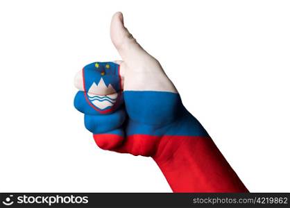 Hand with thumb up gesture in colored slovenia national flag as symbol of excellence, achievement, good, - useful for tourism and touristic advertising and also current positive political, cultural, social management of state or country