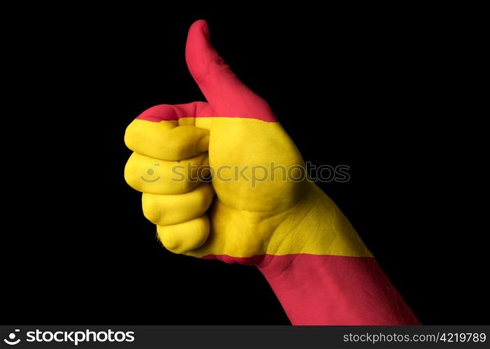 Hand with thumb up gesture in colored spain national flag as symbol of excellence, achievement, good, - useful for tourism and touristic advertising and also current positive political, cultural, social management of state or country