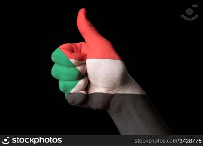 Hand with thumb up gesture in colored sudan national flag as symbol of excellence, achievement, good, - for tourism and touristic advertising, positive political, cultural, social management of country