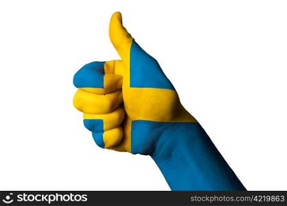 Hand with thumb up gesture in colored sweden national flag as symbol of excellence, achievement, good, - useful for tourism and touristic advertising and also current positive political, cultural, social management of state or country