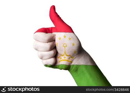 Hand with thumb up gesture in colored tajikistan national flag as symbol of excellence, achievement, good, - for tourism and touristic advertising, positive political, cultural, social management of country
