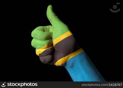 Hand with thumb up gesture in colored tanzania national flag as symbol of excellence, achievement, good, - for tourism and touristic advertising, positive political, cultural, social management of country