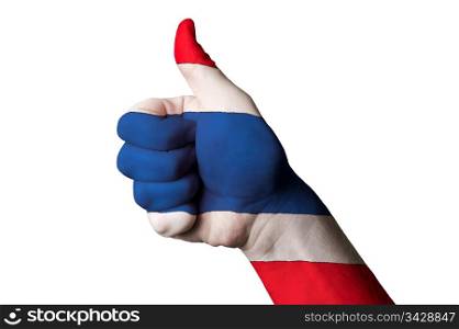 Hand with thumb up gesture in colored thailand national flag as symbol of excellence, achievement, good, - for tourism and touristic advertising, positive political, cultural, social management of country