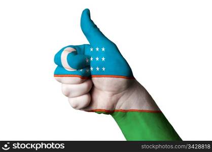 Hand with thumb up gesture in colored uzbekistan national flag as symbol of excellence, achievement, good, - for tourism and touristic advertising, positive political, cultural, social management of country