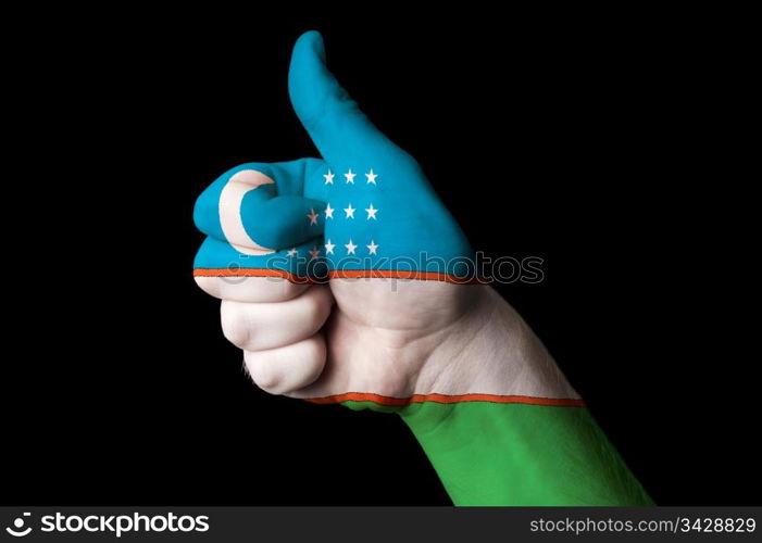 Hand with thumb up gesture in colored uzbekistan national flag as symbol of excellence, achievement, good, - for tourism and touristic advertising, positive political, cultural, social management of country