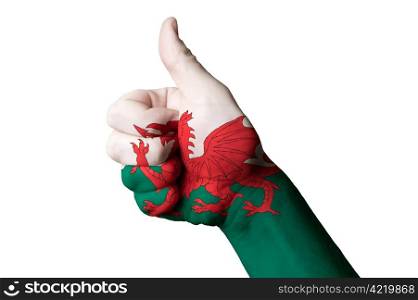 Hand with thumb up gesture in colored wales national flag as symbol of excellence, achievement, good, - useful for tourism and touristic advertising and also current positive political, cultural, social management of state or country