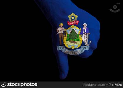 Hand with thumbs down gesture in colored american state of maine flag as symbol of negative political, cultural, social management of country