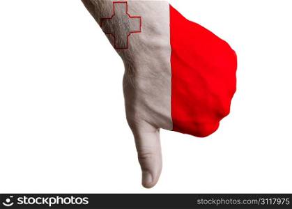 Hand with thumbs down gesture in colored malta national flag as symbol of negative political, cultural, social management of country