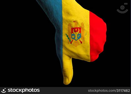 Hand with thumbs down gesture in colored moldova national flag as symbol of negative political, cultural, social management of country