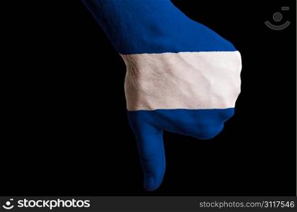 Hand with thumbs down gesture in colored nicaragua national flag as symbol of negative political, cultural, social management of country