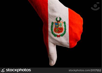 Hand with thumbs down gesture in colored peru national flag as symbol of negative political, cultural, social management of country