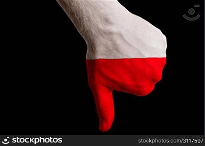 Hand with thumbs down gesture in colored poland national flag as symbol of negative political, cultural, social management of country